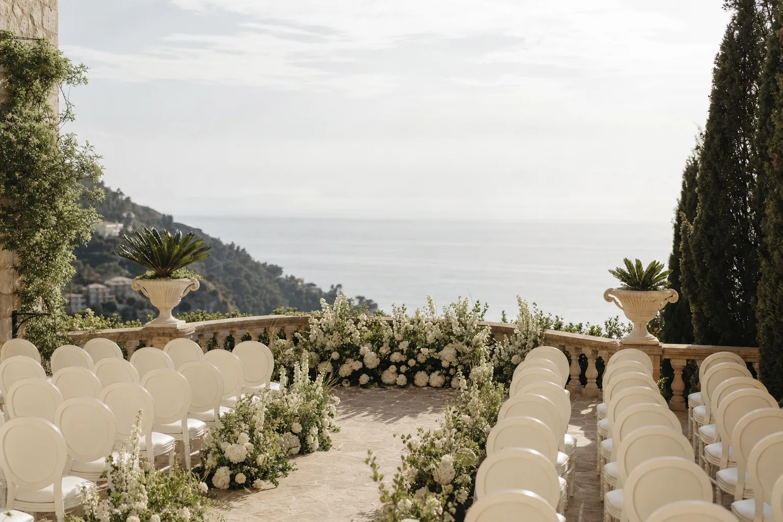Summer terrace wedding setup overlooking the Mediterranean